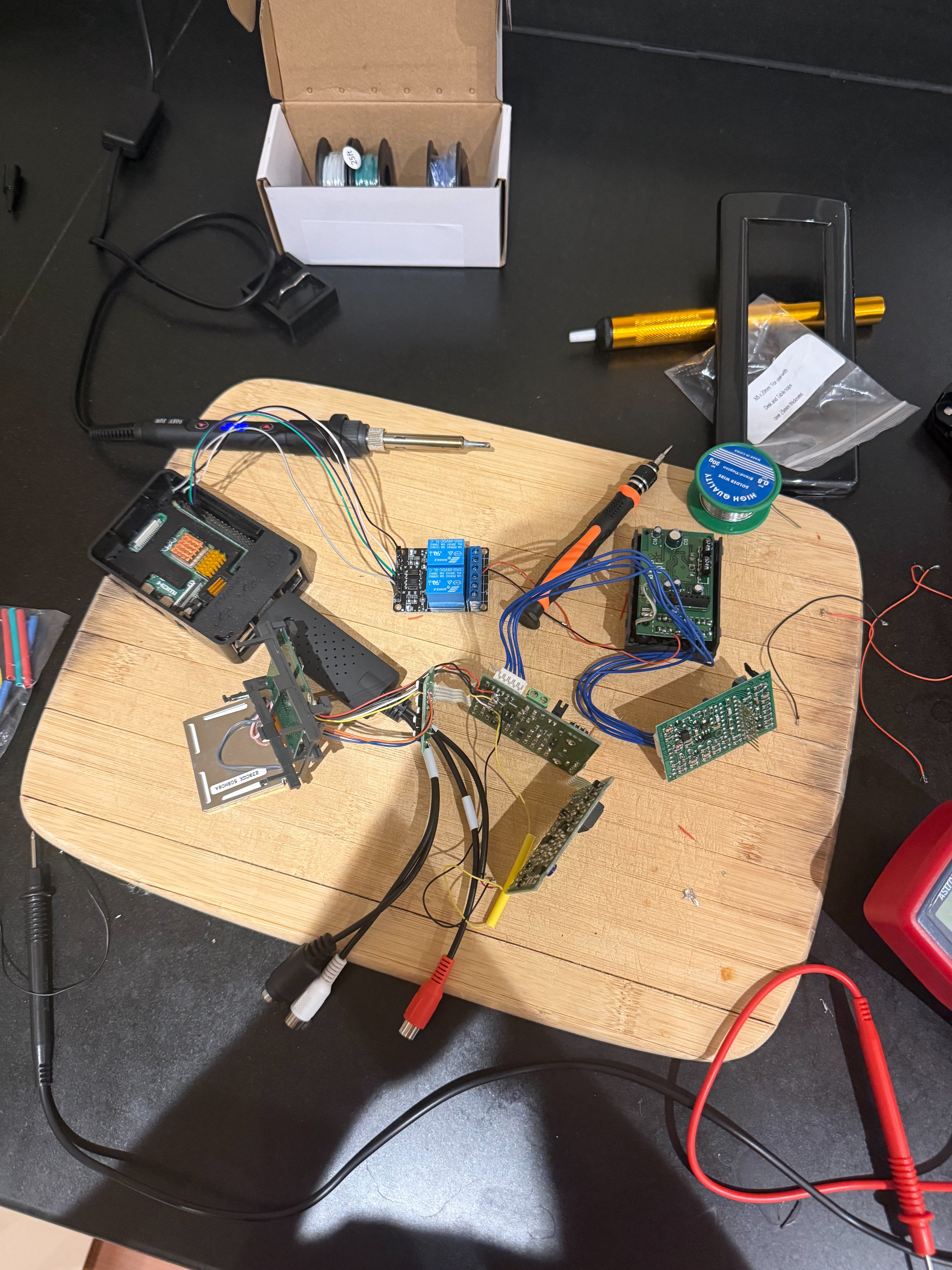The assembled Raspberry Pi, capture card, relay, and wiring spread across a table